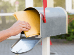 An image of a person putting their results in a mail box